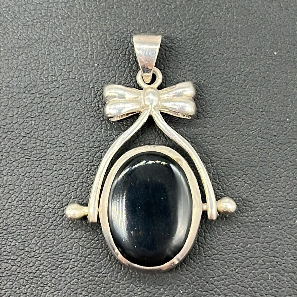 Sterling silver reversible black and white pendant with sweet bow